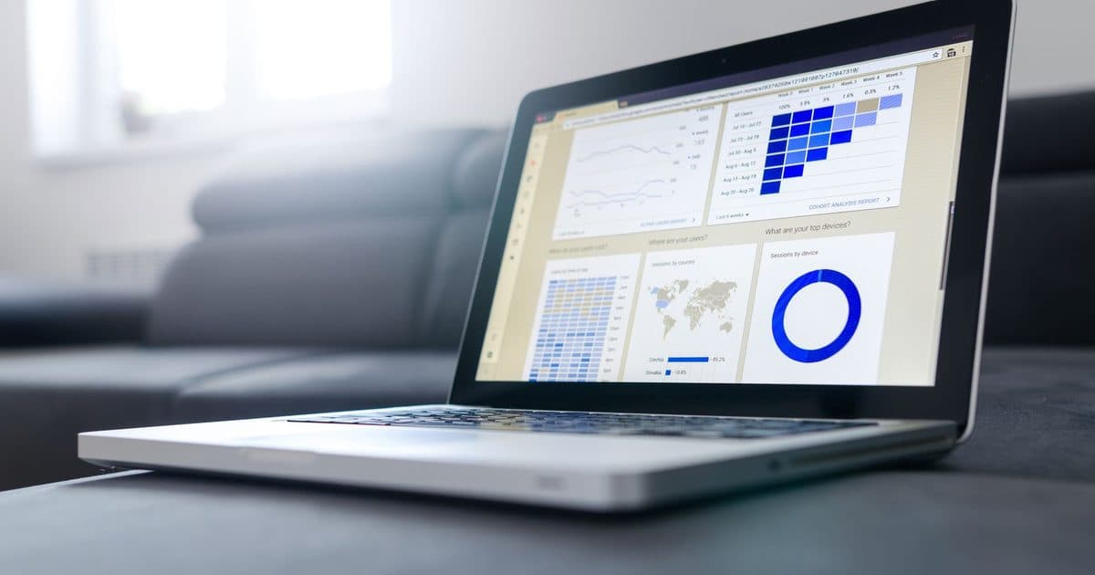 A laptop screen showing a data analytics dashboard with charts.