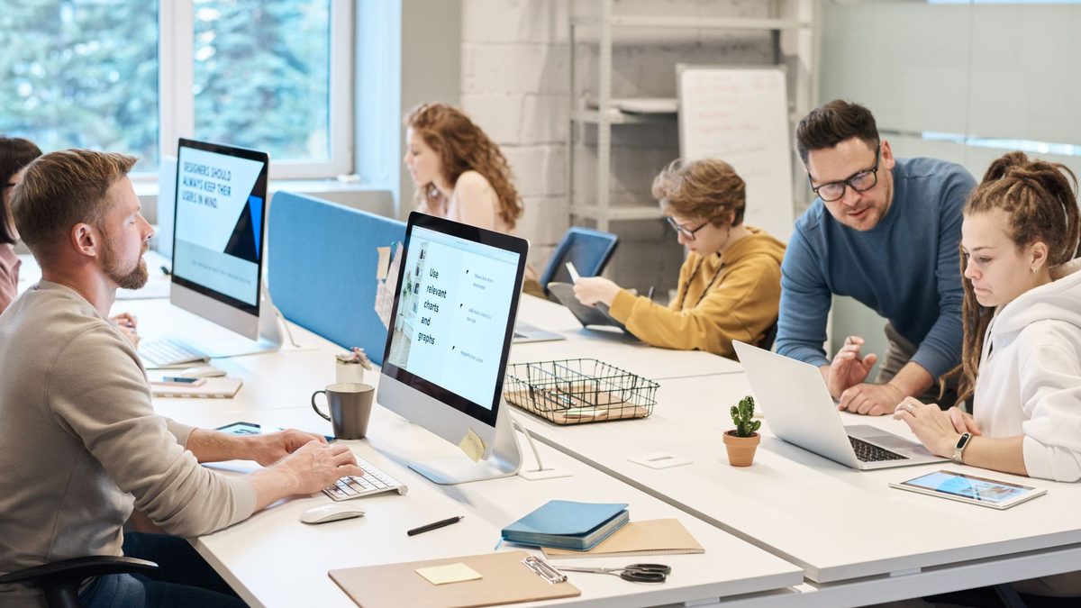 Employees working together in an open-plan office.