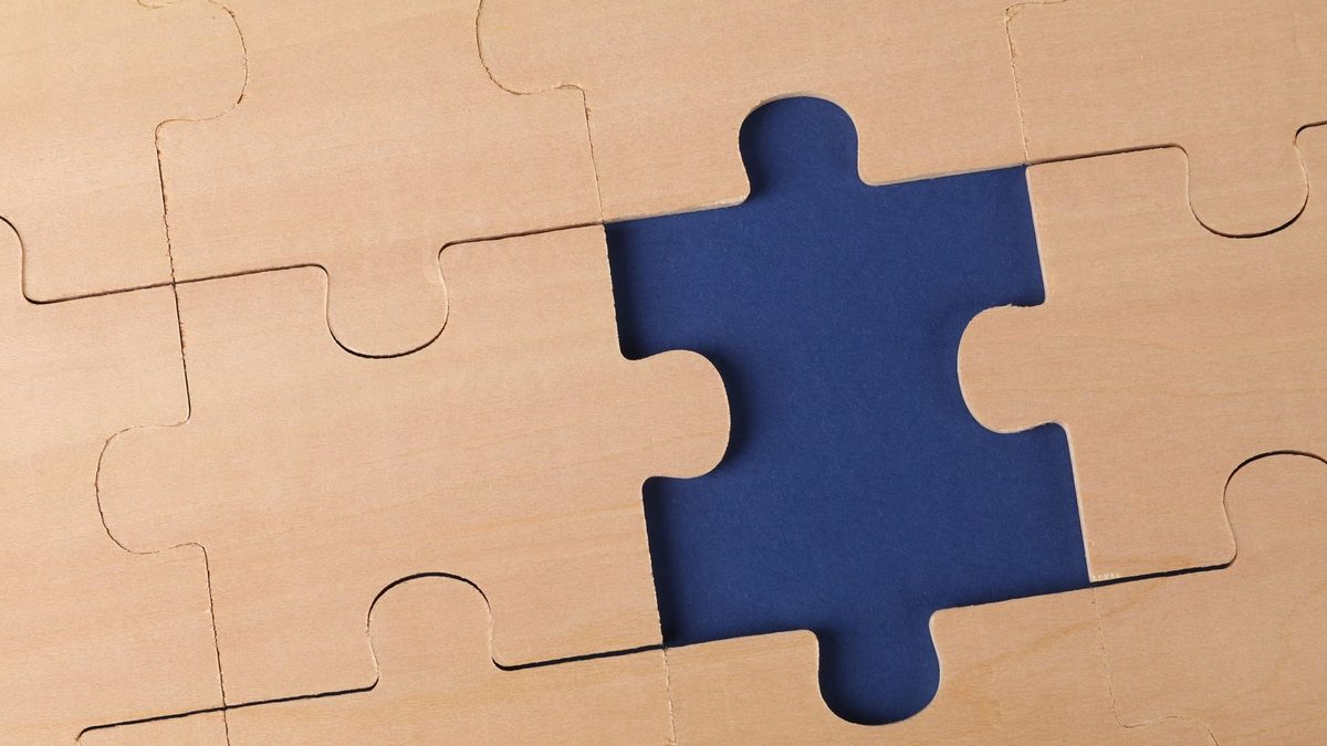 A wooden puzzle with a missing piece.